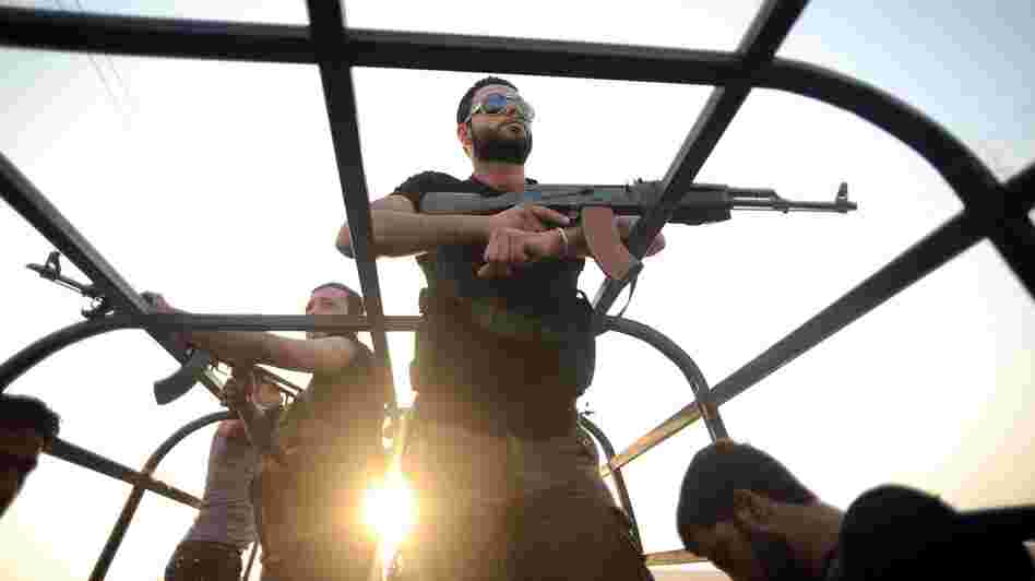 Syrian rebels patrol the streets near Aleppo, Syria.