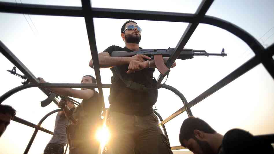 Syrian rebels patrol the streets near Aleppo, Syria.