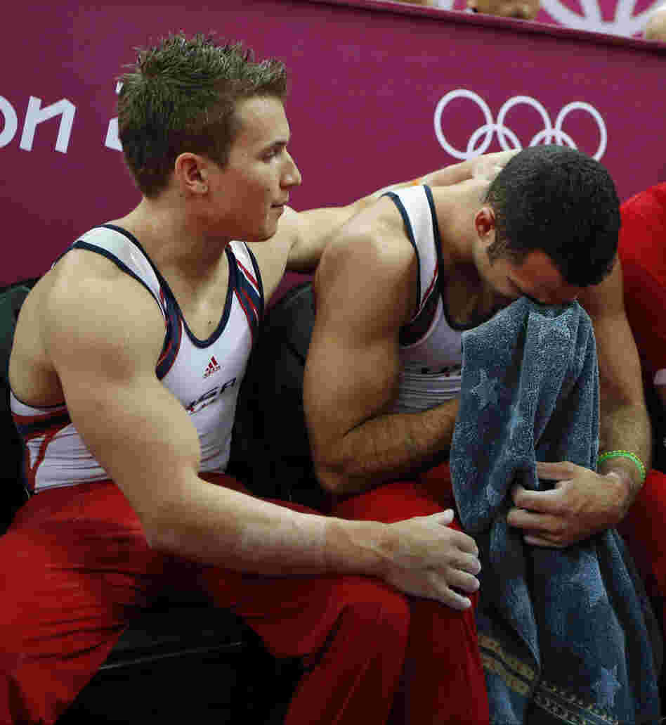 U.S. gymnast Danell Leyva (right) is comforted by teammate Jonathan Horton at the end of the artistic gymnastic men's team final.