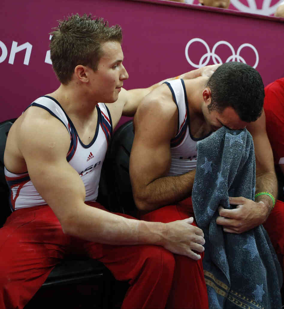 U.S. gymnast Danell Leyva (right) is comforted by teammate Jonathan Horton at the end of the artistic gymnastic men's team final.