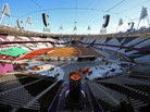 In a mostly empty Olympic Stadium, Austin Playfoot lights the Olympic cauldron Monday morning. The cauldron was extinguished Sunday night, so it could be moved to one end of the stadium. Click the enlargement to see a close-up view. In a mostly empty Olympic Stadium, Austin Playfoot lights the Olympic cauldron Monday morning. The cauldron was extinguished Sunday night, so it could be moved to one end of the stadium. Click the enlargement to see a close-up view.
