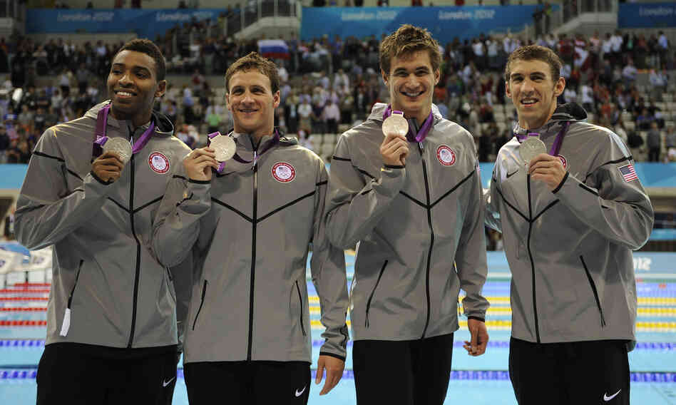 Americans Cullen Jones (from left), Ryan Lochte, Nathan Adrian and Michael Phelps pose with their silver medals for the men's 4x100-meter freestyle relay at the Aquatics Centre on Sunday.