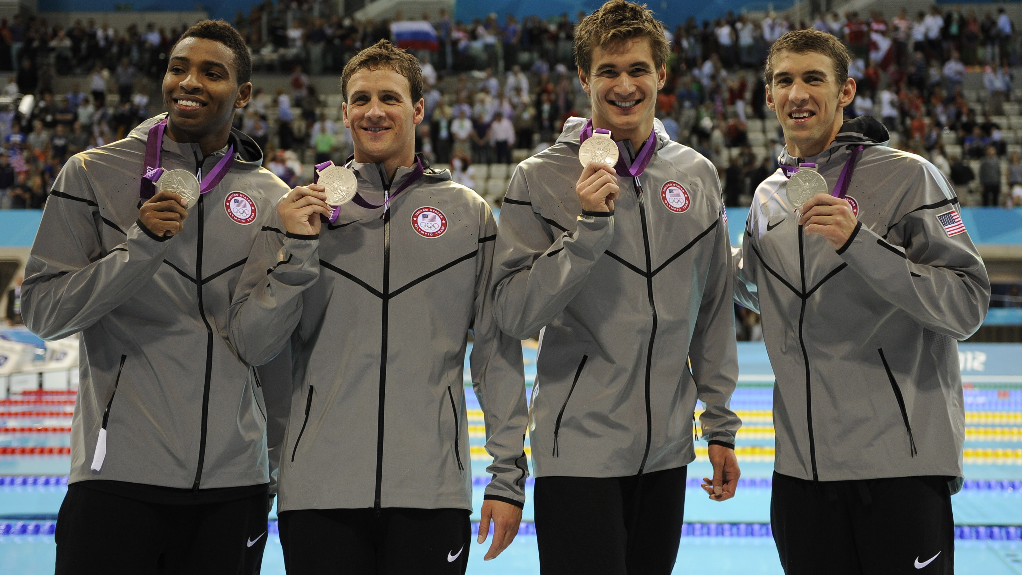Americans Cullen Jones (from left), Ryan Lochte, Nathan Adrian and Michael Phelps pose with their silver medals for the men's 4x100-meter freestyle relay at the Aquatics Centre on Sunday.