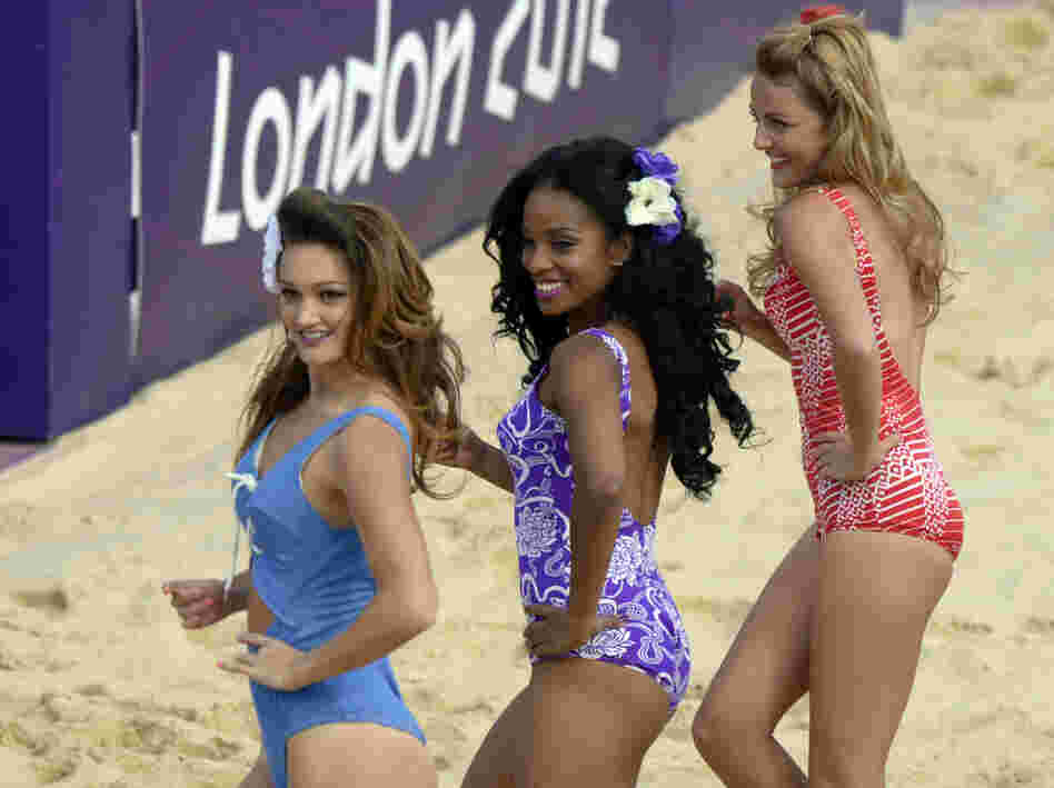 Cheerleaders perform during the women's beach volleyball preliminary phase Pool B match on the Centre Court Stadium at Horse Guards Parade in London on Monday.