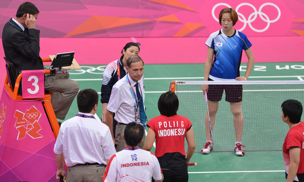 BWF Referee Torsten Berg, center, urges Indonesia's Greysia Polii, center, and Meilana Jauhari, bottom right, and South Korea's Ha Jung Eun, back right, to play fairly in their women's doubles badminton match during the London 2012 Olympic Games in London on Tuesday.