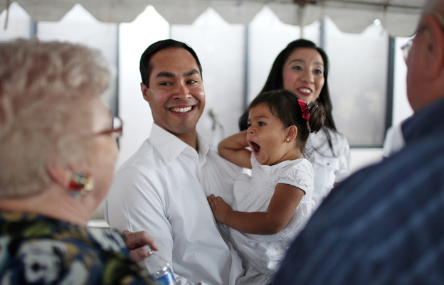 Mayor Julian Castro his daughter Carina, 2, and wife Erica (background) greet supporters at his campaign headquarters in 2011.