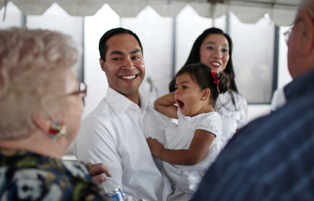 Mayor Julian Castro his daughter Carina, 2, and wife Erica (background) greet supporters at his campaign headquarters in 2011.