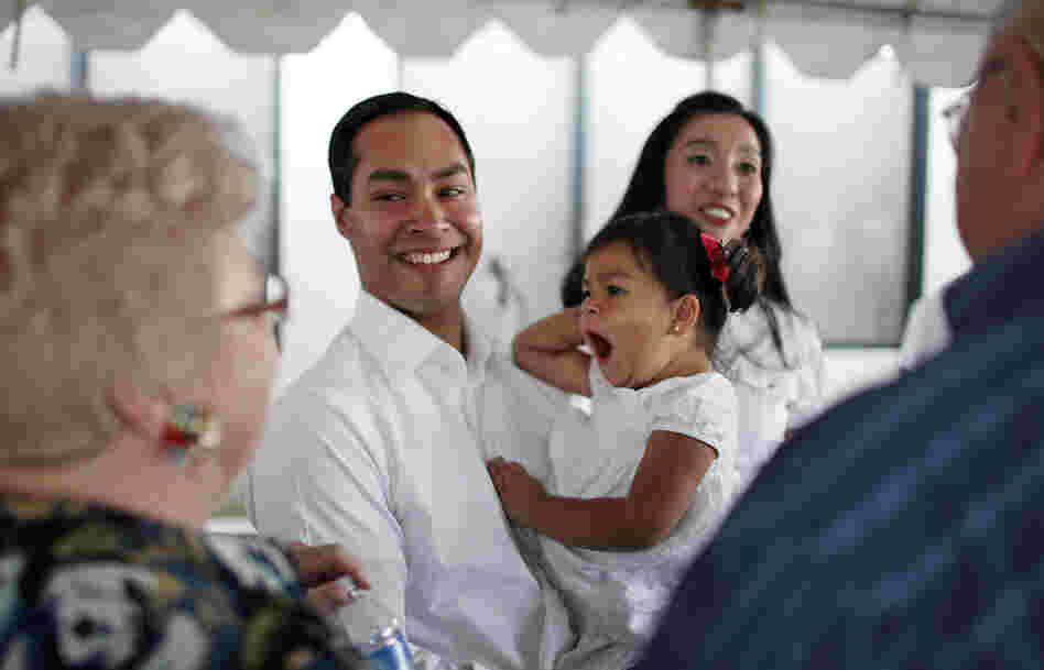 Mayor Julian Castro his daughter Carina, 2, and wife Erica (background) greet supporters at his campaign headquarters in 2011.