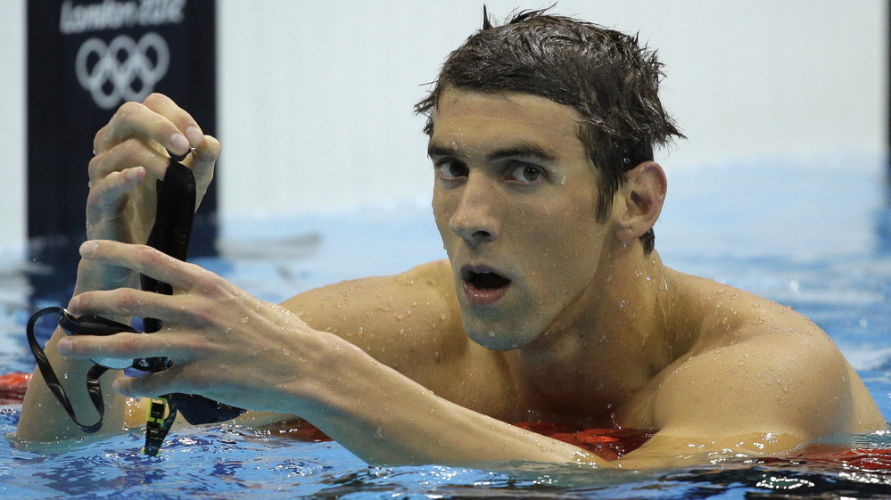 Michael Phelps reacts after winning silver in the men's 200-meter butterfly final at the Aquatics Centre on Tuesday. South Africa's Chad le Clos took home the gold.