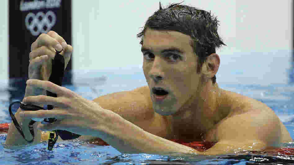 Michael Phelps reacts after winning silver in the men's 200-meter butterfly final at the Aquatics Centre on Tuesday. South Africa's Chad le Clos took home the gold.