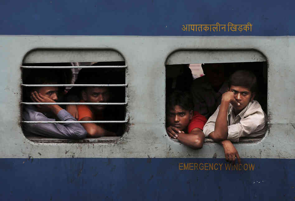 Passengers wait for train service to resume after a power outage in New Delhi. Indian officials say they are rapidly restoring power, but it's unclear how soon the situation will be back to normal.