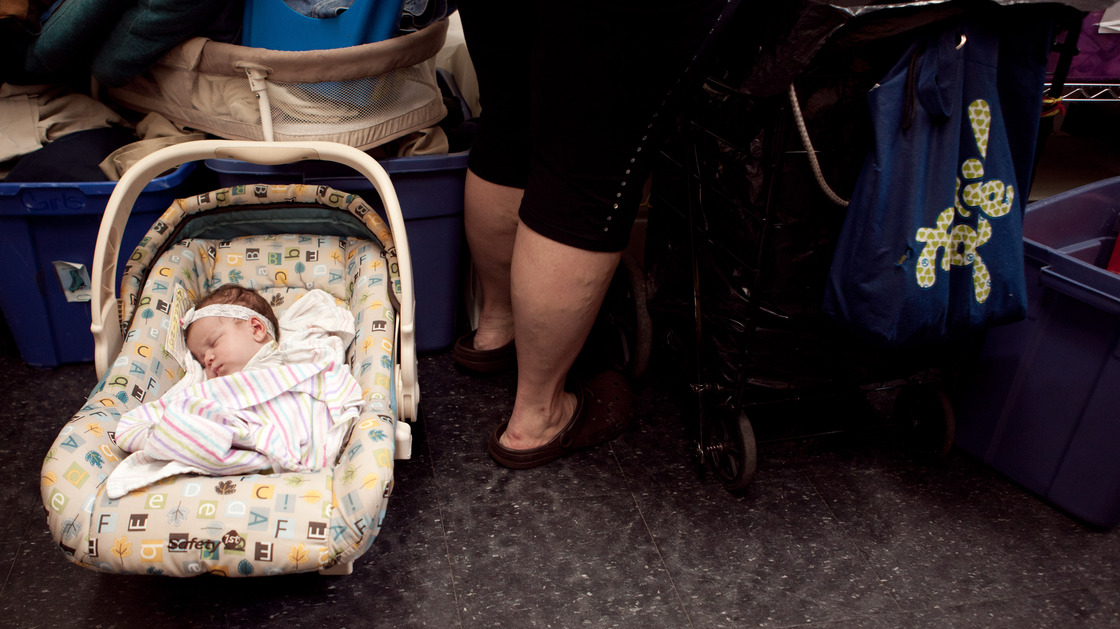 Zaniyah sleeps while her mom shops at the Bread for the City boutique.