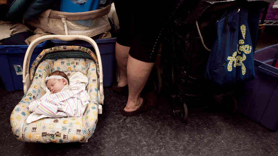 Zaniyah sleeps while her mom shops at the Bread for the City boutique.