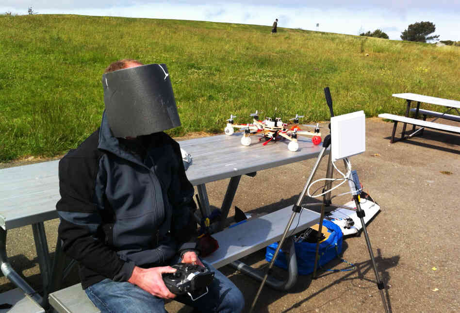 Drone enthusiast Andreas Oesterer wears homemade video goggles, wrapped in gray foam to block out the glare of the sun, as he flies a drone over Cesar Chavez Park.