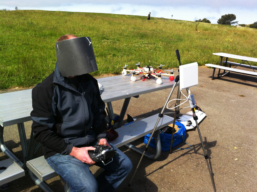 Drone enthusiast Andreas Oesterer wears homemade video goggles, wrapped in gray foam to block out the glare of the sun, as he flies a drone over Cesar Chavez Park.