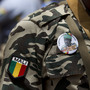 A soldier wears a button bearing the image of coup leader Capt. Amadou Haya Sanogo with the words 'President, CNRDRE,' the French acronym of the ruling junta, as he stands guard at junta headquarters in Kati, outside Bamako, Mali. A soldier wears a button bearing the image of coup leader Capt. Amadou Haya Sanogo with the words 'President, CNRDRE,' the French acronym of the ruling junta, as he stands guard at junta headquarters in Kati, outside Bamako, Mali.
