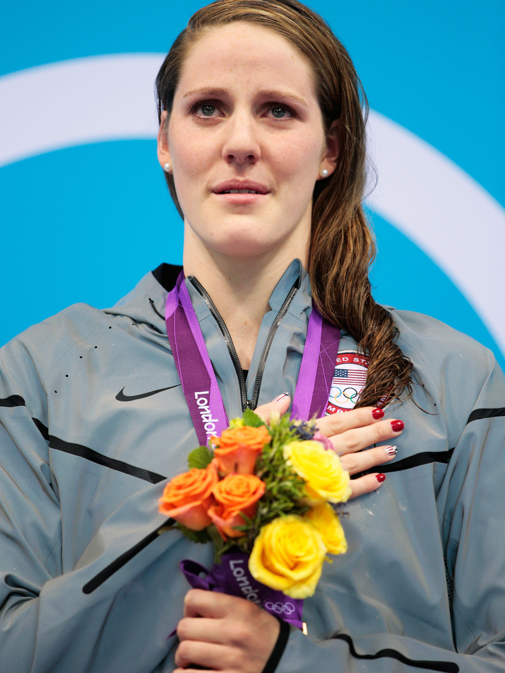 Missy Franklin stands on the podium with her gold medal, after winning the 100m backstroke at the London 2012 Olympic Games. Of that moment, she says, "I was trying to sing, but I was like, crying, at the same time."