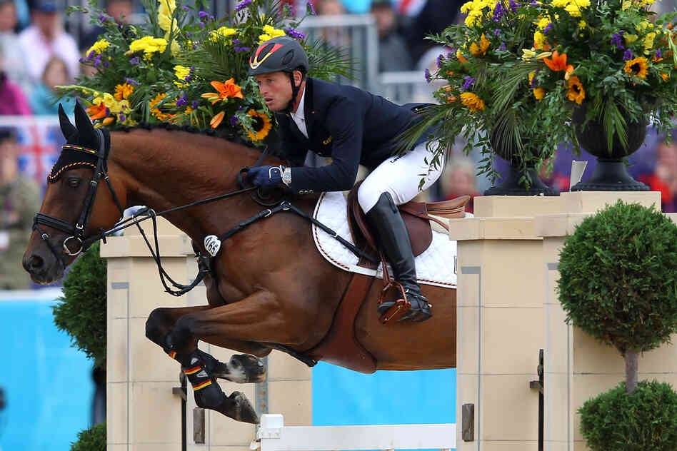 Michael Jung of Germany riding Sam negotiates a jump in the Individual Jumping Equestrian Final. Jung won the event.
