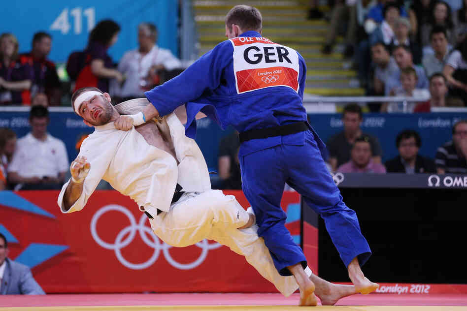 Travis Stevens of the United States (in white) competes against Ole Bischof of Germany in the Men's -81 kg Judo semifinals. Stevens lost the match.