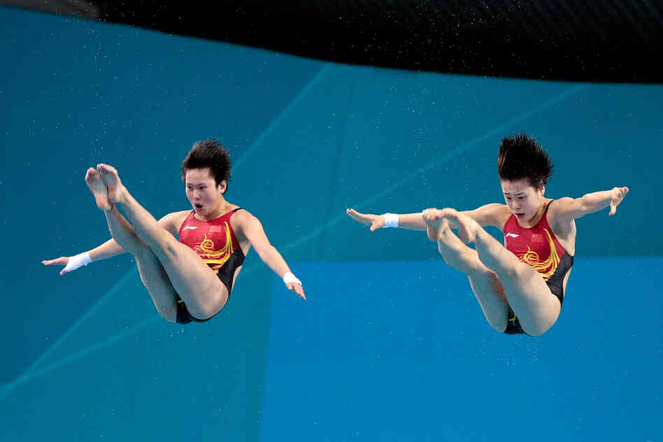 Chen Roulin and Hao Wang and of China compete in the Women's Synchronised 10m Platform Diving. Roulin and Wang won the event.