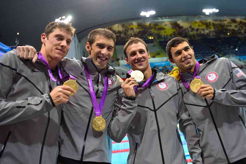 U.S. swimmers Conor Dwyer (left), Michael Phelps, Ryan Lochte, Ricky Berens poses on the podium with their gold medals after winning the men's 4x200m freestyle relay final at the London 2012 Olympic Games.