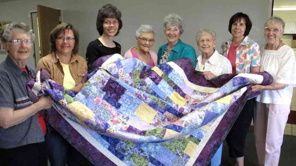Juanita Ryan (far left), Lori Westphal, Maureen Foster, Othelia Schulz, Karen Pagett, Delores Rosin, Kim Randall, Gladys Pearce. The sewing circle tries to help abused women and children start new lives.