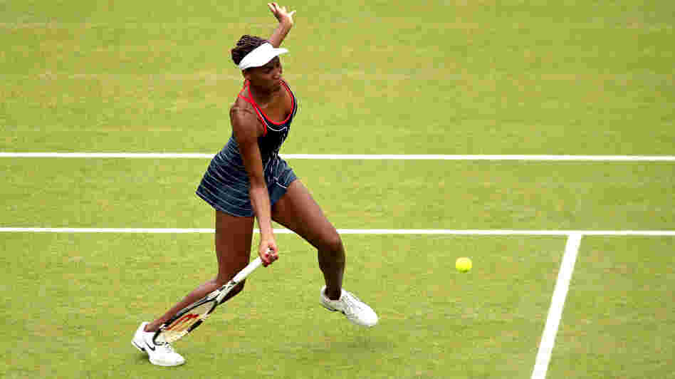 Venus Williams of the United States returns a shot to Aleksandra Wozniak of Canada in their Olympic singles tennis match, played at Wimbledon. Williams won, 6-1, 6-3.