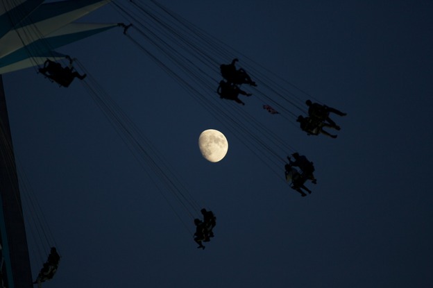 A waxing moon in the background of a fairground attraction in London on Sunday.