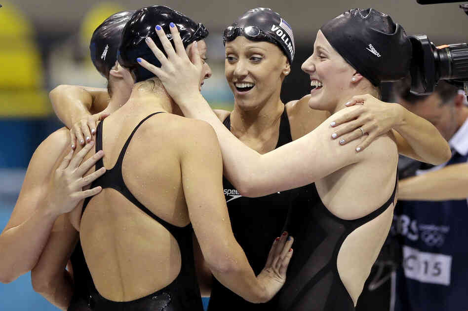 U.S. swimmers Shannon Vreeland (left), Missy Franklin, Allison Schmitt, and Dana Vollmer (center)embrace after they won gold in the women's 4x200-meter freestyle relay final.