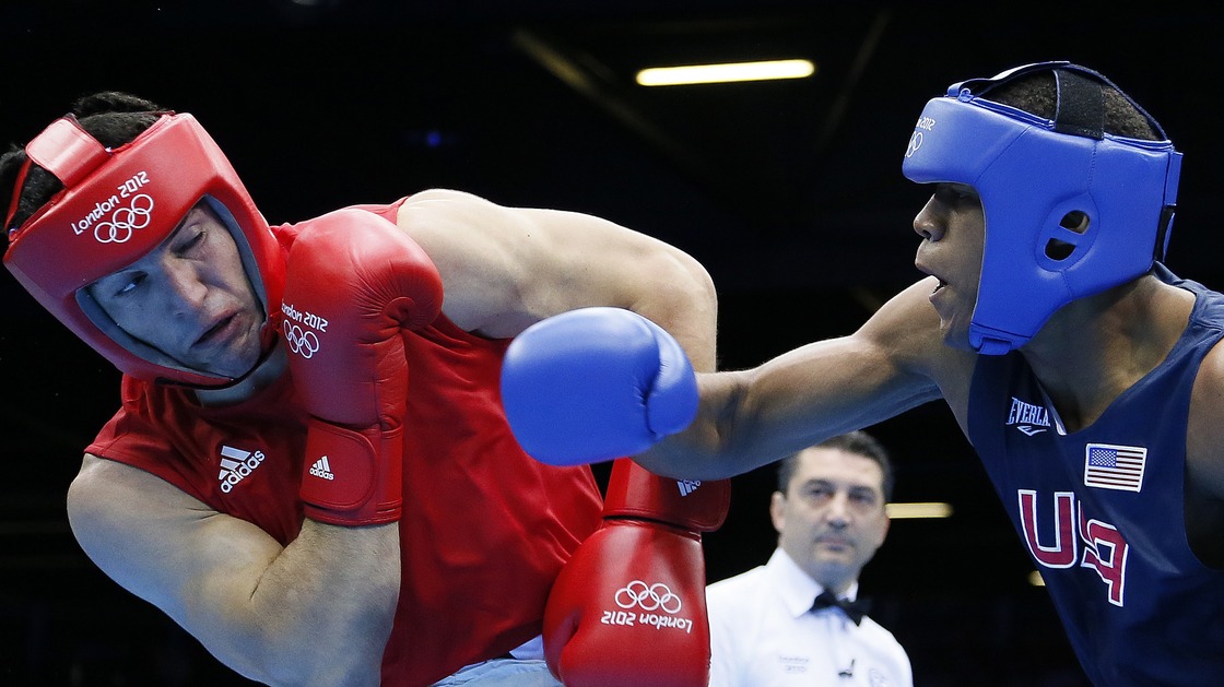 Boxer Michael Hunter Jr. of the U.S. lost a close bout to Artur Beterbiev (left) of Russia in the heavyweight division's Round of 16 at the ExCel Arena Wednesday.