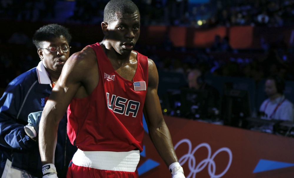 Jamel Herring of the U.S. departs the ring after his loss to Daniyar Yeleussinov in their boxing match at the London Olympics. Herring, an active-duty Marine, is the U.S. team captain.