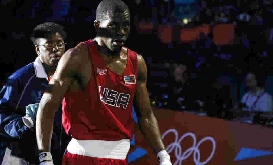 Jamel Herring of the U.S. departs the ring after his loss to Daniyar Yeleussinov in their boxing match at the London Olympics. Herring, an active-duty Marine, is the U.S. team captain.