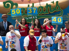 Five-time reigning champion Joey Chestnut, second from left, competes in Nathan's Famous Hot Dog Eating World Championship on July 4 this year.