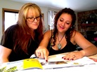Emily Macri looks over a college brochure with her mother, Maureen O'Brien, in Kingman, Ariz. Macri is transferring to Northern Arizona University so that she can pay in-state tuition. Emily Macri looks over a college brochure with her mother, Maureen O'Brien, in Kingman, Ariz. Macri is transferring to Northern Arizona University so that she can pay in-state tuition.