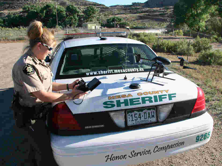 Deputy Amanda Hill of the Mesa County Sheriff's Office in western Colorado prepares to use a Draganflyer X6 drone equipped with a video camera to help search for a suspect in a knife attack in this undated photo.