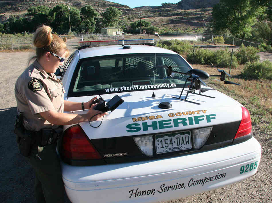 Deputy Amanda Hill of the Mesa County Sheriff's Office in western Colorado prepares to use a Draganflyer X6 drone equipped with a video camera to help search for a suspect in a knife attack in this undated photo.