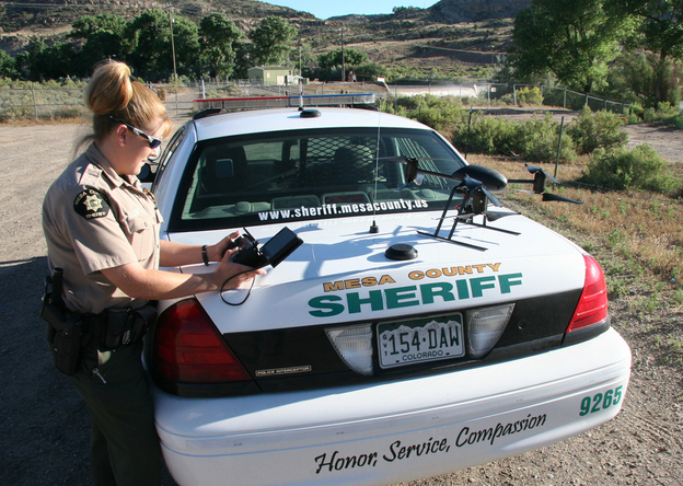Deputy Amanda Hill of the Mesa County Sheriff's Office in western Colorado prepares to use a Draganflyer X6 drone equipped with a video camera to help search for a suspect in a knife attack in this undated photo.