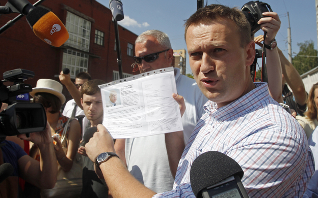 Russian protest leader Alexei Navalny speaks to the media as he arrives for questioning at the headquarters of the Russian Investigation committee in Moscow on Monday.