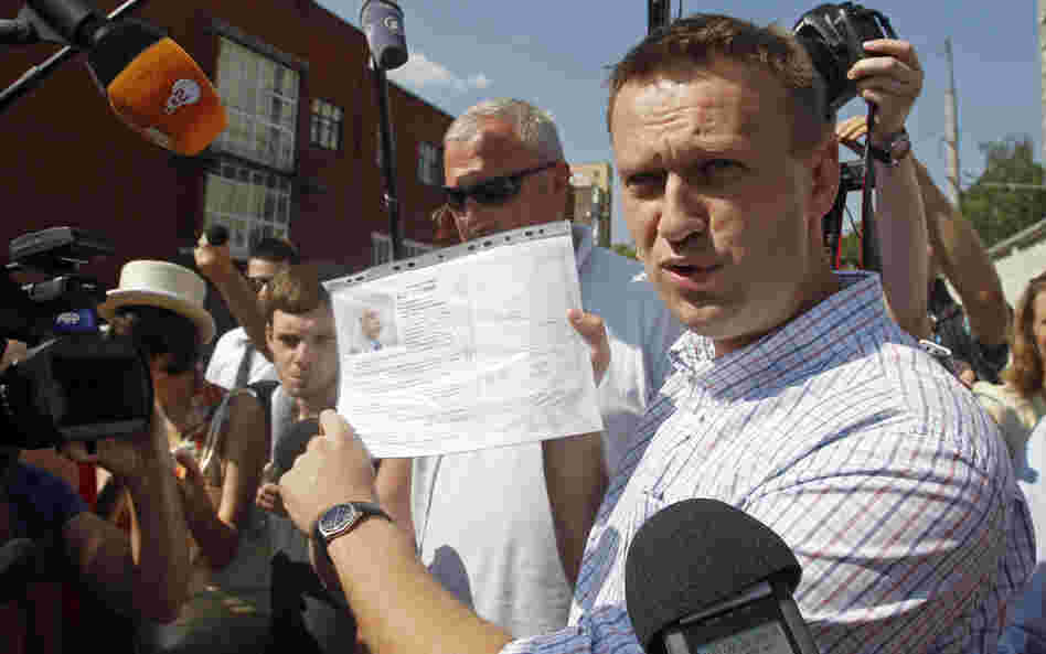 Russian protest leader Alexei Navalny speaks to the media as he arrives for questioning at the headquarters of the Russian Investigation committee in Moscow on Monday.