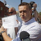 Russian protest leader Alexei Navalny speaks to the media as he arrives for questioning at the headquarters of the Russian Investigation committee in Moscow on Monday.