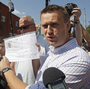 Russian protest leader Alexei Navalny speaks to the media as he arrives for questioning at the headquarters of the Russian Investigation committee in Moscow on Monday. Russian protest leader Alexei Navalny speaks to the media as he arrives for questioning at the headquarters of the Russian Investigation committee in Moscow on Monday.