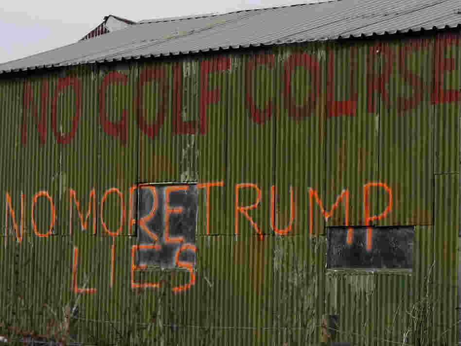 Graffiti on a shed captures the opposition to Donald Trump's planned golf course on the Aberdeenshire coastline in Scotland. Graffiti on a shed captures the opposition to Donald Trump's planned golf course on the Aberdeenshire coastline in Scotland.