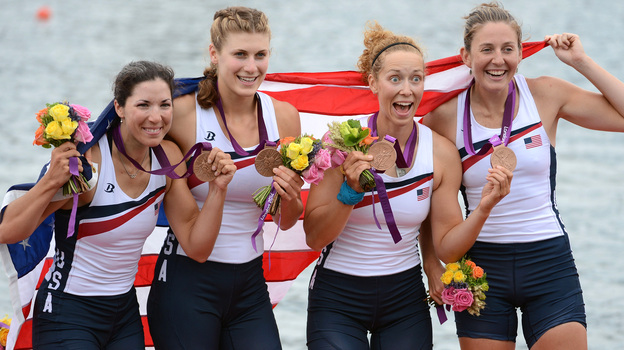 Adrienne Martelli, Megan Kalmoe, Kara Kohler and Natalie Dell of the United States celebrate on the podium after winning bronze in the women's quadruple sculls at Eton Dorney in Windsor, England.