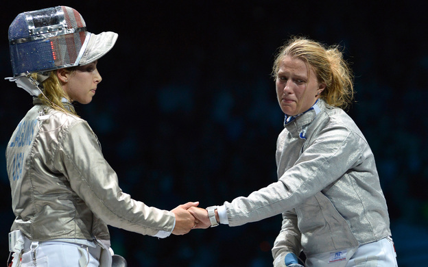 American fencer Mariel Zagunis (left), the two-time gold medal winner in sabre, shakes hands after losing to Ukraine's Olga Kharlan in their bronze medal match at London's ExCel Center.