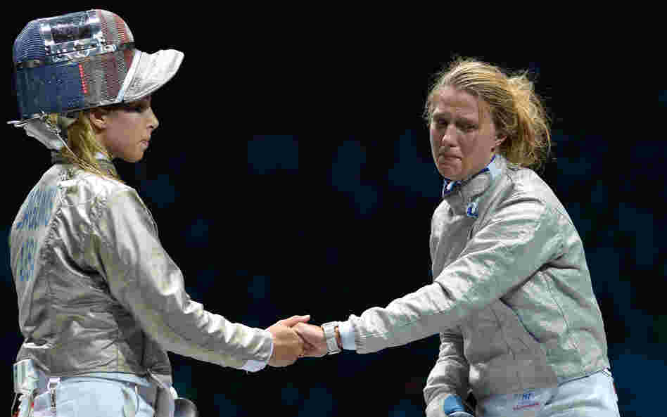 American fencer Mariel Zagunis (left), the two-time gold medal winner in sabre, shakes hands after losing to Ukraine's Olga Kharlan in their bronze medal match at London's ExCel Center.
