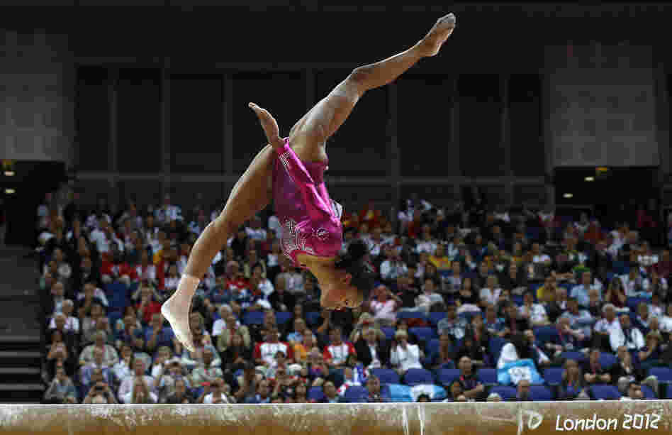 Gabrielle Douglas performs Thursday on the beam during the artistic gymnastics women's individual all-around final. Some people are focusing on her hair rather than her skill.