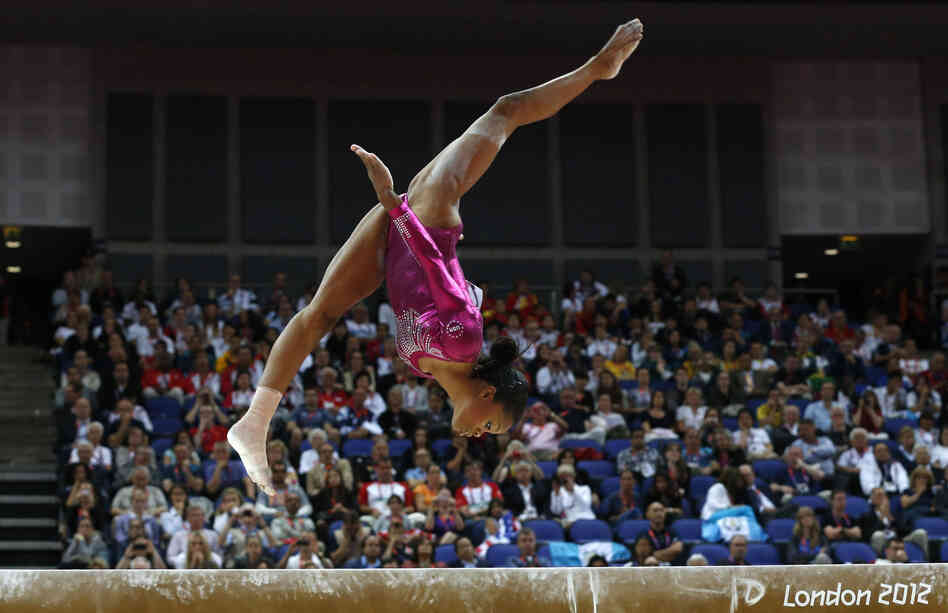 Gabrielle Douglas performs Thursday on the beam during the artistic gymnastics women's individual all-around final. Some people are focusing on her hair rather than her skill.