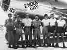 American bomber pilot Paul W. Tibbets Jr. (center) stands with the ground crew of the bomber Enola Gay, which Tibbets flew in the atomic bombing of Hiroshima, Tinian island, Northern Marianas, August 1945.