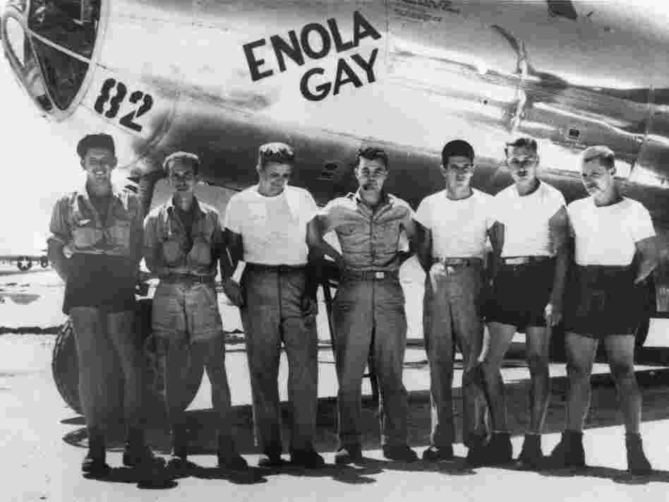 American bomber pilot Paul W. Tibbets Jr. (center) stands with the ground crew of the bomber Enola Gay, which Tibbets flew in the atomic bombing of Hiroshima, Tinian island, Northern Marianas, August 1945.