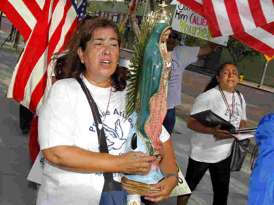 Rosa Maria Soto protests Maricopa County Sheriff Joe Arpaio outside the federal courthouse on July 19 in Phoenix. It was the first day of a trial that accuses Arpaio's office of racially profiling Latinos.